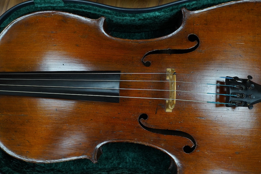 A cased late 19th century German? cello, body length 75cm, together with two bows. Condition - fair to good.